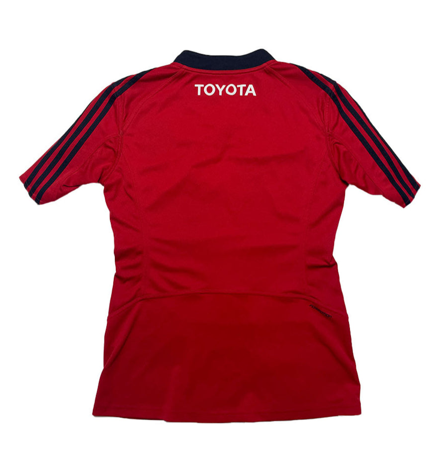Red sports jersey with 'Toyota' logo on the back against a white background