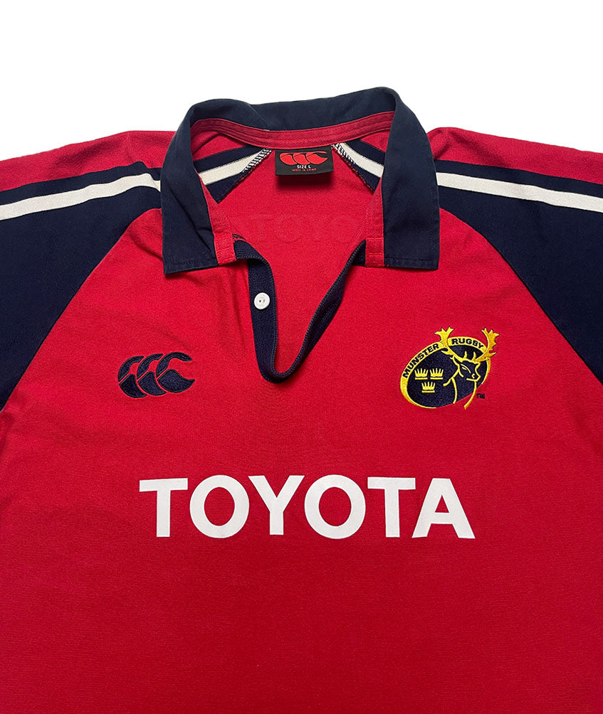 Red rugby jersey with navy accents, Toyota logo, and club emblem on a white background
