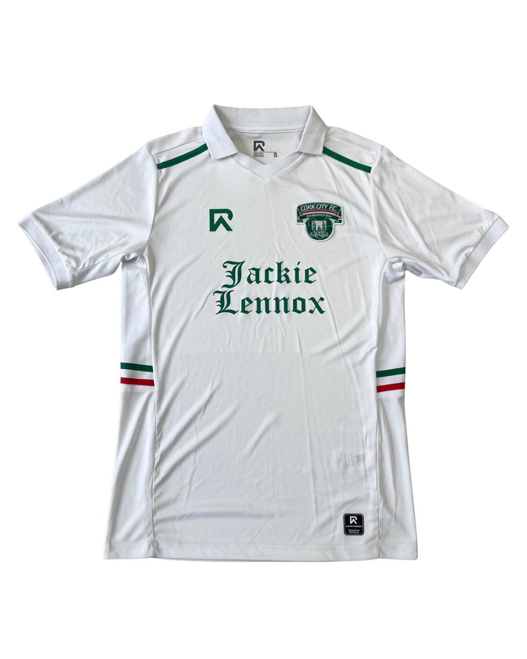 A white short-sleeve soccer jersey with green and red accents, featuring the text 'Jackie Lennox' across the chest and a club crest on the left chest. The jersey is displayed flat against a white background.